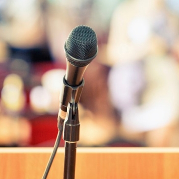 an open microphone in front of a crowd